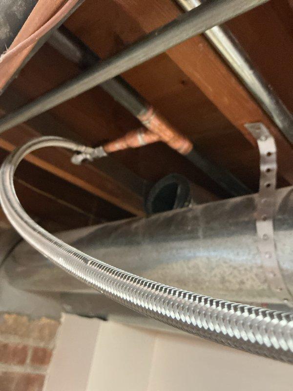 Replaced outdated ice maker saddle valve with a code-compliant quarter-turn shut off valve on 3/4" copper water supply line. The new valve installation provides reliable water control and eliminates potential leak points associated with the old saddle valve configuration.
