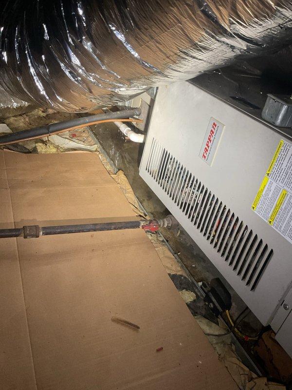 Responded to priority call for water leak originating from above bathroom in century-old home. Upon investigation, inspected Bradford White water heater located in narrow utility closet adjacent to bathroom and accessed attic space above to identify leak source. Examined HVAC system, plumbing connections, and surrounding infrastructure in attic crawl space with reflective insulation. Assessed water heater installation, supply lines, and drainage connections to determine origin of moisture intrusion affecting bathroom ceiling below.