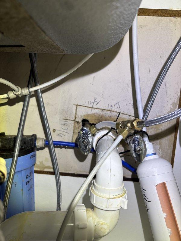Responded to emergency call for burst pipe in commercial office building with century-old plumbing infrastructure. Upon arrival via back entrance, located and isolated the failed section of piping in the under-sink cabinet area. Inspected existing plumbing system including garbage disposal connections, PVC drain lines, and water supply lines with filtration system. Replaced damaged pipe section and verified integrity of surrounding connections, including flexible supply lines, shut-off valves, and braided stainless steel hoses. Tested all connections for leaks and confirmed proper water pressure restoration throughout the affected area.
