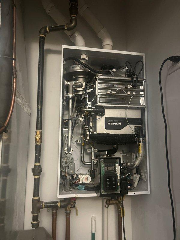 Completed diagnostic evaluation of 10-year-old Navien tankless water heater that experienced operational failure. Performed comprehensive visual inspection of unit's internal components, heat exchanger, piping connections, and venting system. Documented current condition of equipment and all associated plumbing infrastructure to provide estimate for repair or replacement options.