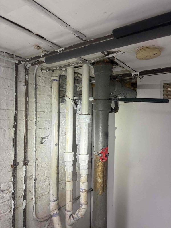 Conducted on-site assessment of multi-unit building's first-floor plumbing requirements for comprehensive kitchen and bathroom remodeling project. Evaluated existing basement plumbing infrastructure including water supply lines, drainage systems, and gas connections to determine scope of work for adding dishwasher and refrigerator waterlines, installing washer hookup, setting customer-supplied toilet fixture, and converting gas range connection to accommodate electric appliance installation.