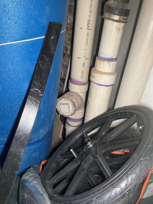 Responded to water backup affecting drains and toilet in garden unit of century-old building. Upon inspection, discovered standing water and moisture accumulation on basement floor near drainage system. Assessed plumbing infrastructure including PVC drain lines and floor drain assembly to identify blockage source. Cleared main sewer line obstruction causing backup through building's drainage system, restoring proper flow and eliminating water intrusion into living spaces.