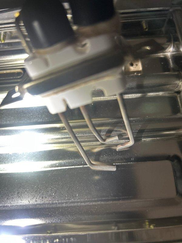 Performed annual maintenance service on tankless water heater system, completing a comprehensive flush procedure to remove mineral buildup and scale deposits from the heat exchanger assembly. Inspected internal components including the copper heat exchanger coils, mounting brackets, and finned surfaces, documenting the condition with photographs showing normal wear patterns and minor accumulation of debris between the metallic fins.