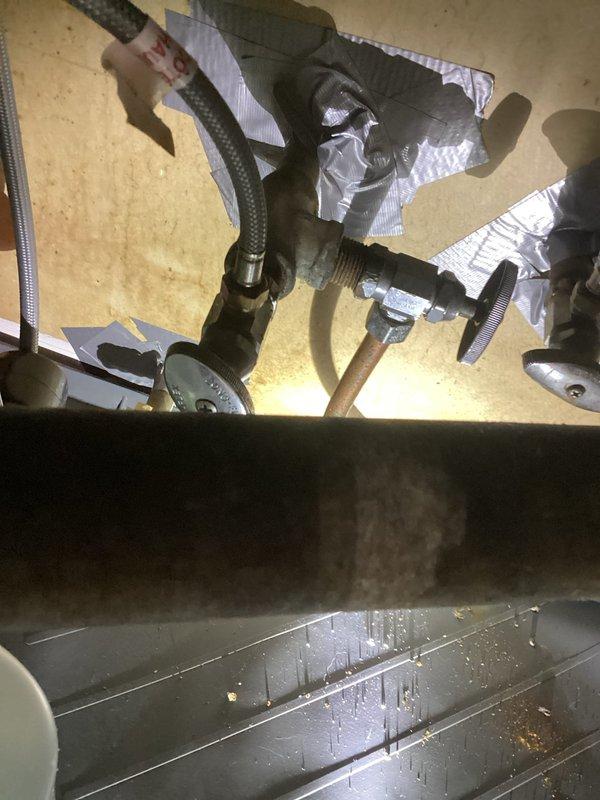 Replaced faulty angle stop valve with new chrome-plated quarter-turn shut-off valve and completed dishwasher installation, including connection of water supply lines with brass compression fittings and proper mounting of all plumbing fixtures beneath the cabinet. Verified all connections were secure and leak-free upon testing.