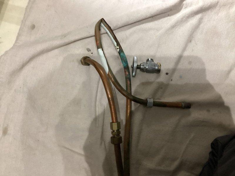 Replaced faulty angle stop valve with new chrome-plated quarter-turn shut-off valve and completed dishwasher installation, including connection of water supply lines with brass compression fittings and proper mounting of all plumbing fixtures beneath the cabinet. Verified all connections were secure and leak-free upon testing.