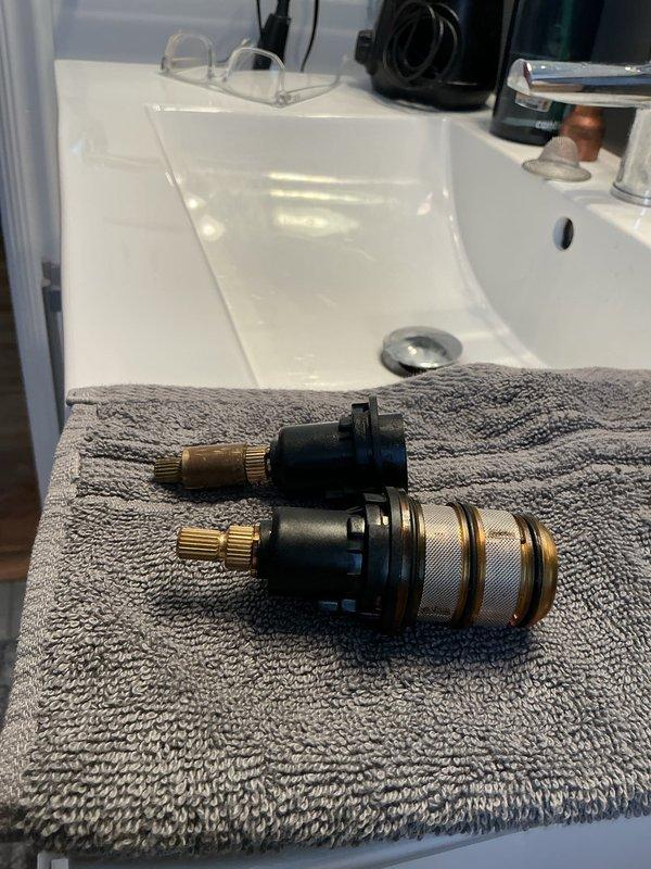 Responded to emergency plumbing call for shower valve leak with tub filling uncontrollably and water unable to be shut off. Diagnosed failed shower valve cartridges causing continuous water flow and loss of shut-off control. Removed and replaced defective valve cartridges to restore proper water control and eliminate leak, preventing potential flooding damage.
