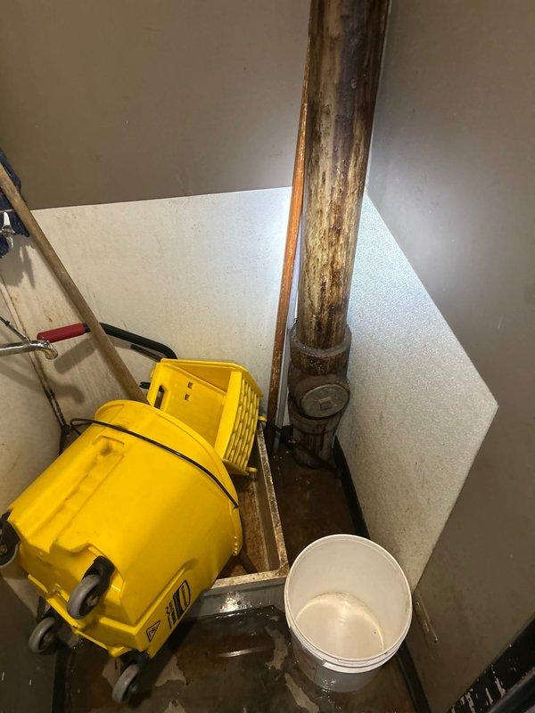 Responded to a commercial sewer backup issue in a restroom facility where drainage obstruction was causing recurring backups. Conducted initial assessment revealing severely corroded vertical copper piping with extensive oxidation and water damage, necessitating water mitigation equipment deployment. Recommended video camera inspection of the sewer line to identify the exact location and nature of the obstruction and determine appropriate repair scope for the compromised drainage system.