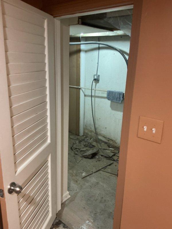Completed plumbing service evaluation in utility room undergoing renovation. Assessed existing plumbing infrastructure and water heater installation in space with exposed concrete flooring and construction debris. Documented current conditions of utility connections, electrical junction boxes, and conduit routing for ongoing renovation work.