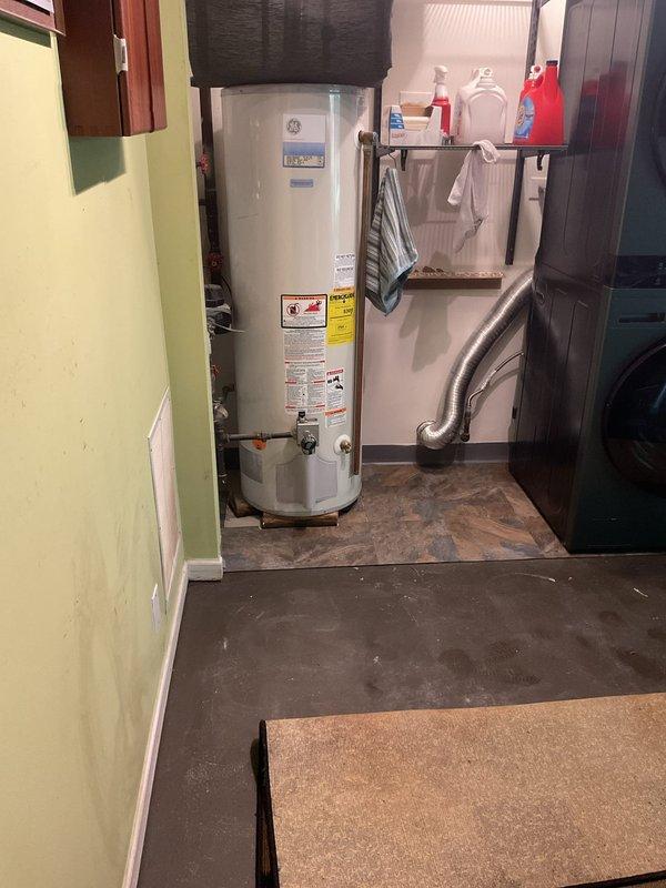 Responded to a 3-story townhome experiencing multiple drainage issues including ground floor toilet bubbling and floor drain backup following heavy rain, as well as recurring third floor toilet stoppages that resulted in a loosened toilet seal and water damage to the second floor ceiling. Inspected plumbing system and documented conditions at ground floor utility area near water heater and affected bathroom fixtures. Identified suspected sanitary drain blockage as primary cause requiring further investigation and clearance of main drainage line.