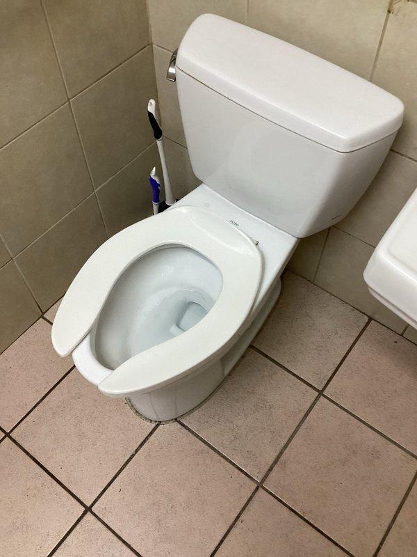 Conducted commercial plumbing assessment for ejector pump and toilet installation in facility with existing moisture damage. Evaluated bathroom area with deteriorated flooring and water-damaged surfaces indicating need for waste pump system. Documented existing toilet fixture and compromised utility room conditions with visible water intrusion patterns on concrete flooring. Provided estimate for ejector pump installation to address drainage requirements and complete toilet installation in area with inadequate gravity drainage capability.
