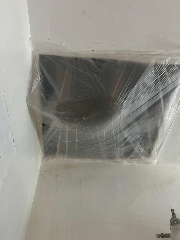 Responded to water leak from ceiling complaint and performed diagnostic investigation. Inspected bathroom area and identified potential leak source affecting HVAC air handler unit. Protected mechanical equipment with plastic sheeting to prevent further water damage while assessment was conducted. Documented conditions with photographs for estimate preparation.