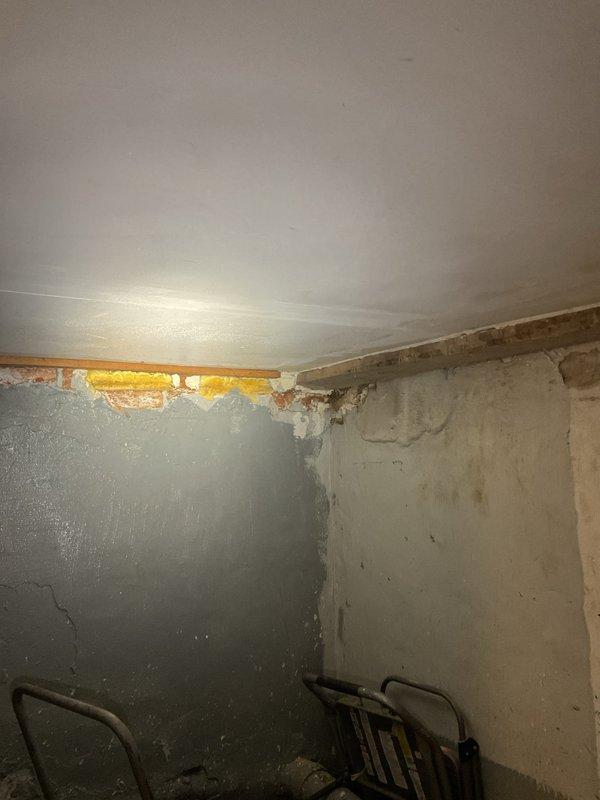 Responded to report of gas leak at property. Upon arrival, conducted thorough inspection of gas lines and connections throughout accessible areas including crawl space and interior rooms. Utilized gas detection equipment to identify source of leak. Inspection revealed compromised gas piping in crawl space area where black gas pipe runs through foundation wall opening. Visual assessment documented deteriorated conditions including exposed insulation, structural gaps at wall-ceiling junctions, and aging infrastructure that may have contributed to gas line movement or connection failure. Performed pressure test on gas system to verify leak location and assess system integrity. Documented findings with photographs showing crawl space conditions, exposed piping with visible marking bands, and interior structural damage that required attention. Advised customer of findings and recommended immediate repairs to address gas leak hazard and restore safe operation of gas system.