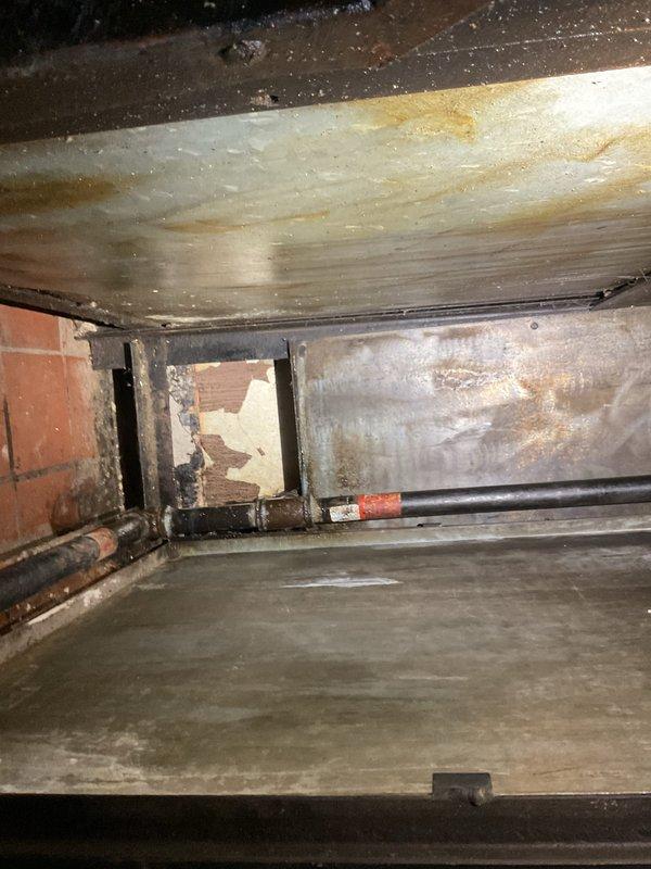 Responded to report of gas leak at property. Upon arrival, conducted thorough inspection of gas lines and connections throughout accessible areas including crawl space and interior rooms. Utilized gas detection equipment to identify source of leak. Inspection revealed compromised gas piping in crawl space area where black gas pipe runs through foundation wall opening. Visual assessment documented deteriorated conditions including exposed insulation, structural gaps at wall-ceiling junctions, and aging infrastructure that may have contributed to gas line movement or connection failure. Performed pressure test on gas system to verify leak location and assess system integrity. Documented findings with photographs showing crawl space conditions, exposed piping with visible marking bands, and interior structural damage that required attention. Advised customer of findings and recommended immediate repairs to address gas leak hazard and restore safe operation of gas system.