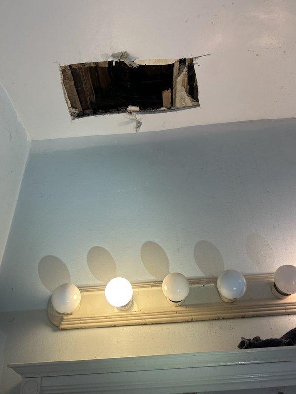 Responded to emergency same-day service request for plumbing repairs. Upon arrival, assessed bathroom plumbing system and identified active water flow issues at bathtub faucet assembly with three chrome-finished fixtures mounted on tiled wall. Additionally, discovered significant water damage to ceiling above bathroom vanity area, with structural compromise exposing wooden framing and damaged drywall material, indicating probable leak from plumbing system above. Performed necessary repairs to address immediate plumbing concerns and restore proper water control functionality to bathtub fixtures.
