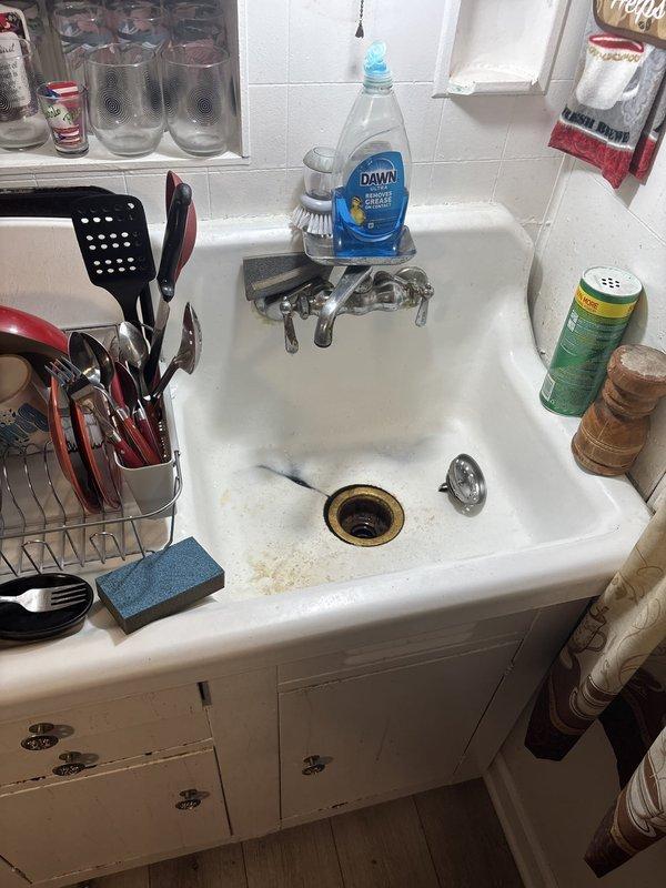 Responded to priority water leak repair in kitchen area where water was seeping up through the floor. Upon inspection, identified leak originating from under-sink plumbing system, specifically at the PVC drain pipe connection to the sink drain fixture. Inspected all visible plumbing connections beneath the sink, noting discoloration and residue on the lower portion of the drain pipe indicating active moisture intrusion. Repaired the compromised connection, tested the system for proper drainage and seal integrity, and confirmed no further water leakage through the kitchen floor.