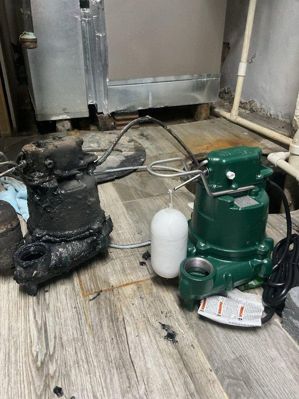 Responded to flooding complaint in basement area following heavy rainfall. Upon inspection, discovered failed sump pump system with severely corroded and deteriorated pump unit that was no longer operational. Removed old damaged pump and installed new green residential-grade sump pump with float switch assembly. Routed discharge line from basement through foundation to exterior of building, laying flexible drainage tubing across mulched landscape area away from structure to prevent water from returning to foundation. Tested new sump pump system for proper operation and verified adequate drainage flow through exterior discharge line. System now functioning properly to prevent future basement flooding during rain events.