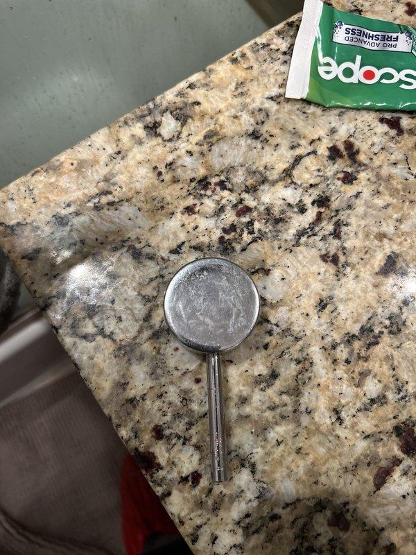 Responded to service call for broken and stripped shower handle. Upon inspection, found the shower valve stem exposed with the handle completely broken off the valve body. The existing trim plate showed significant age and water damage. Documented the condition of the fixture mounted on the brick wall and provided estimate for replacement shower handle and trim components to restore proper function to the shower control valve.