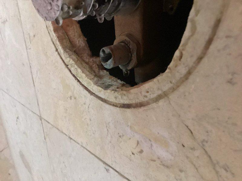 Completed plumbing repair service involving assessment and documentation of existing bathtub and shower fixture installation. Inspected copper supply lines, shower valve assembly with lever control, tub spout, and drain components mounted on tiled wall surface. Evaluated plumbing connections at wall penetration points and verified proper fixture alignment and functionality of the bathtub/shower combination system.
