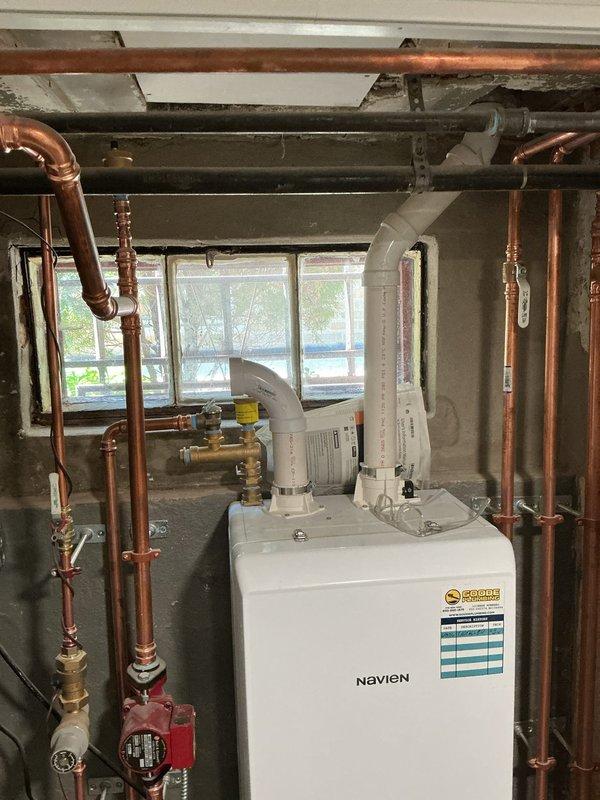 Responded to warranty call for gas leak on recently installed Navien tankless water heater. Upon arrival, performed comprehensive safety inspection of unit and all gas connections. Located leak at gas supply line connection point using approved leak detection solution. Shut down gas supply and depressurized system per manufacturer protocol. Removed and inspected threaded connection, identified insufficient thread sealant application on original installation. Cleaned threads thoroughly, applied appropriate yellow CSST-rated thread sealant, and reinstalled connection with proper torque specifications. Pressurized gas line and conducted leak test on all connections including inlet valve, union fittings, and manifold connections—all tests negative. Verified proper combustion air intake and exhaust venting through PVC termination. Restored gas supply, purged air from lines, and restarted unit. Monitored ignition sequence and confirmed stable flame with proper combustion characteristics. Tes