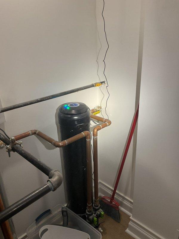 Responded to low water pressure complaint affecting the residence when multiple fixtures were in use simultaneously. Inspected the primary shower drain and removed debris obstruction. Evaluated the water supply system including the water heater and filtration equipment, verifying proper operation of all plumbing connections and pressure regulation components.