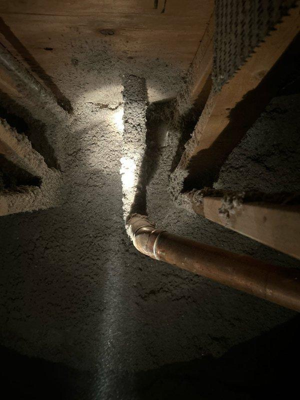 Responded to crawl space inspection revealing severe mold contamination on floor joists, plywood sheathing, and copper plumbing lines. Documented extensive white fungal growth blanketing wooden structural members and piping system, indicating prolonged moisture intrusion. Assessed aged copper trap configuration and surrounding infrastructure for water damage and structural integrity. Sold comprehensive mold remediation and moisture control repair to address contaminated crawl space conditions and prevent further deterioration of building components.