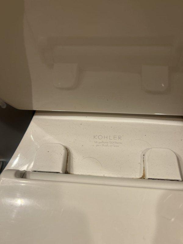 Serviced Kohler pressure-assist toilet equipped with Flushmate MHBS-4K1 pressure vessel system (1.0 gpf). Contacted customer to confirm arrival time and obtain service authorization prior to commencing work. Inspected and documented pressure vessel components, verifying proper labeling and safety specifications, and assessed overall toilet condition including tank lid and bowl assembly.