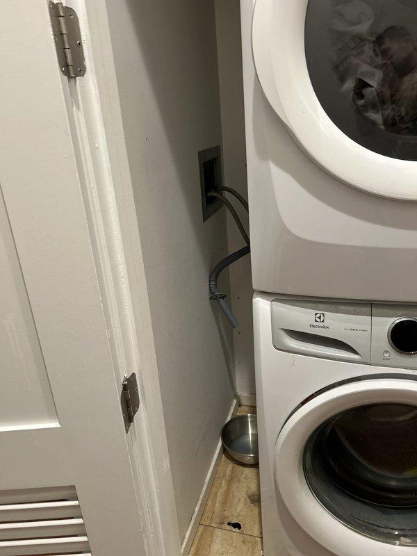Responded to water leak service call in laundry/utility area. Upon inspection, identified potential leak source near washing machine location and placed collection container on closet floor as temporary measure to capture water. Customer requested return visit scheduled for Tuesday to complete permanent repair work.