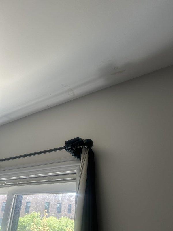 Responded to water intrusion complaint with visible ceiling stains in bathroom. Conducted thorough inspection of affected areas, identifying moisture damage patterns on ceiling surfaces near wall junction. Traced leak source to upper-level plumbing system, performed necessary repairs to stop active water infiltration, and verified proper drainage function to prevent future damage.