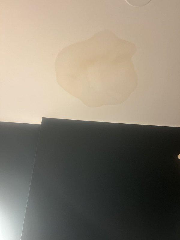 Responded to water intrusion complaint with visible ceiling stains in bathroom. Conducted thorough inspection of affected areas, identifying moisture damage patterns on ceiling surfaces near wall junction. Traced leak source to upper-level plumbing system, performed necessary repairs to stop active water infiltration, and verified proper drainage function to prevent future damage.