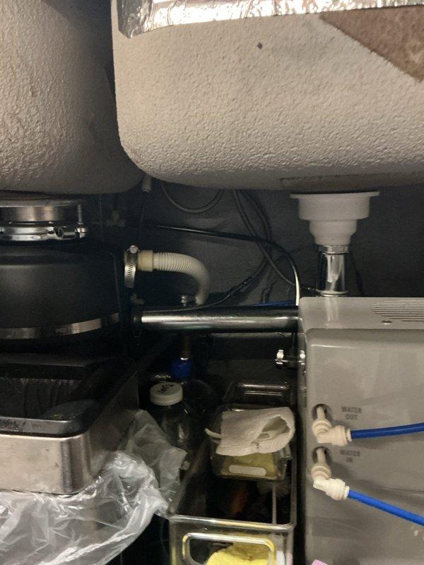 Responded to service call for low water pressure at kitchen sink with professional-style pull-down spray faucet. Upon inspection, tested water flow at the faucet spray head and observed reduced pressure output. Examined the undermount double-bowl stainless steel sink installation and inspected all visible plumbing connections beneath the sink, including supply lines, shut-off valves, and drain assemblies. Checked for potential obstructions in the aerator and spray head, verified proper function of the pull-down mechanism, and assessed supply line condition and valve operation to identify the source of pressure reduction.