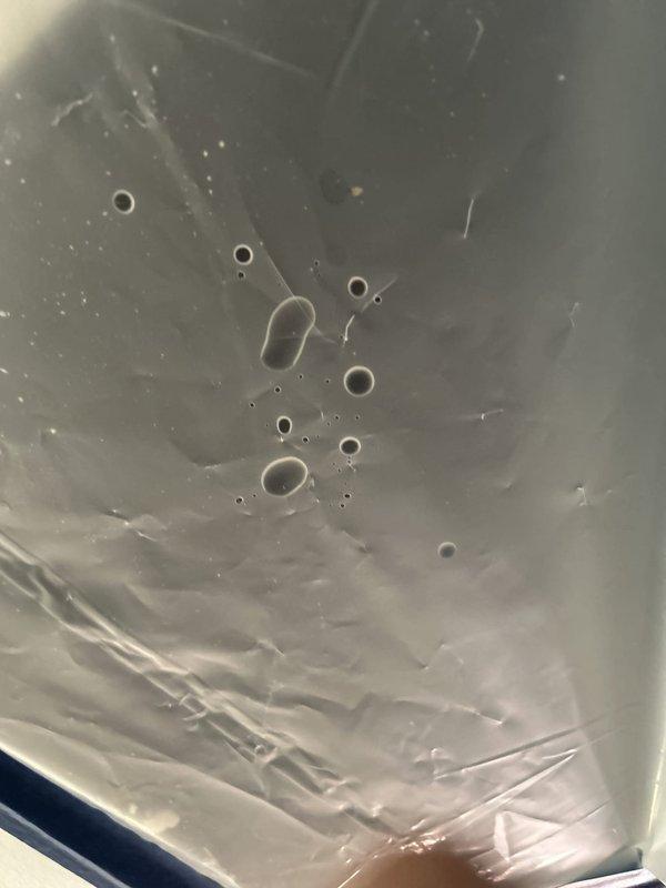 Responded to water leak investigation following ceiling access by litigation company. Upon inspection, identified compromised toilet flange with significant corrosion around drain opening and deteriorated wax ring seal causing water intrusion. Documented existing conditions showing rust damage to flange assembly, degraded sealing materials, and residue on surrounding tile floor requiring remediation and proper reinstallation of toilet fixture.