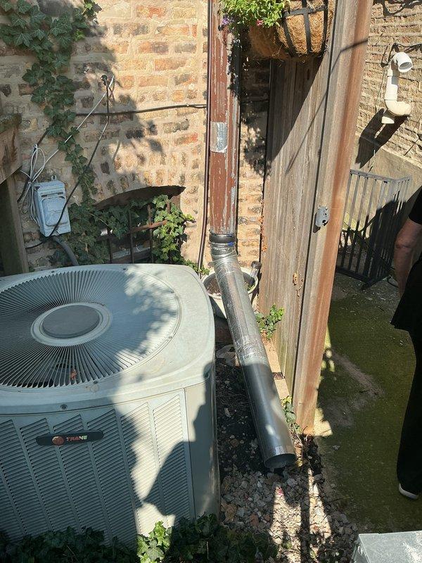 Responded to warranty call for flooding issue following recent trench drain installation. Upon arrival, conducted thorough inspection of the drainage system and surrounding area, including the trench drain grate and concrete surface conditions. Documented existing site conditions with photographs showing the drain location, HVAC equipment placement, and evidence of water accumulation and organic growth on concrete surfaces. Assessed drainage functionality and identified potential causes of flooding concern to determine warranty coverage and necessary corrective measures.