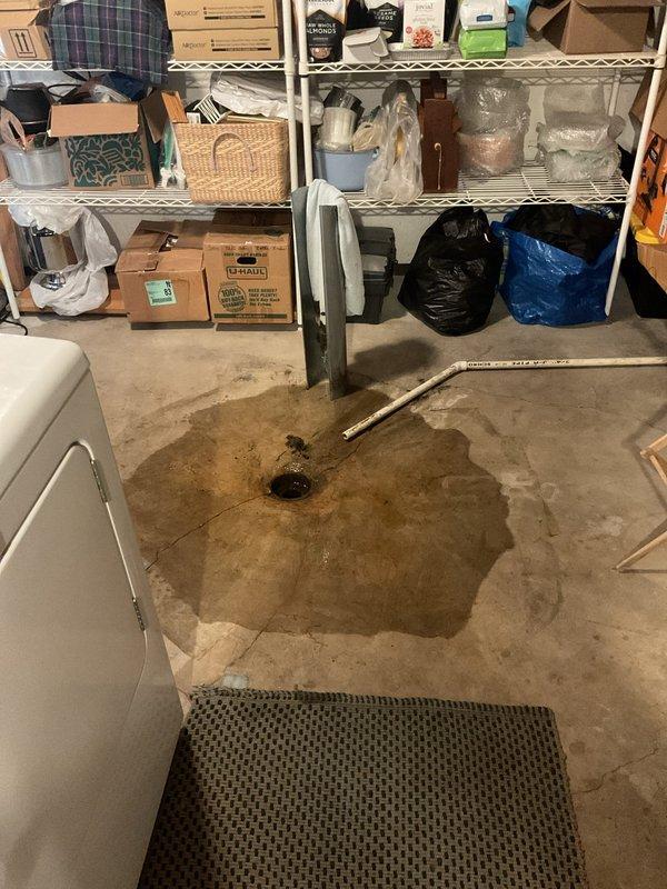 Responded to main drain line blockage affecting drainage to city sewer connection. Upon arrival, found evidence of backup with water accumulation on basement floor near floor drain. Successfully cleared obstruction in main drain cleanout using professional drain cleaning equipment. Verified proper flow restoration through drain line to municipal sewer system, with all fixtures draining normally upon completion.