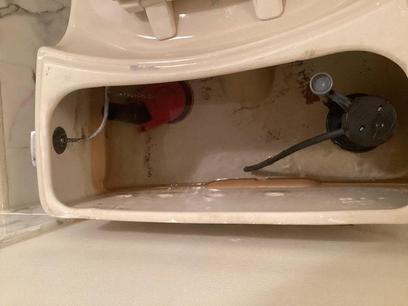Completed toilet flapper and chain replacement in residential bathroom. Upon inspection, found existing flapper valve and metal chain showing wear and mineral buildup consistent with normal deterioration. Removed old components, installed new flapper assembly with properly adjusted chain length to ensure correct flush valve operation and seal. Tested flush mechanism multiple times to verify proper operation, adequate tank refill, and complete water shutoff after flush cycle.