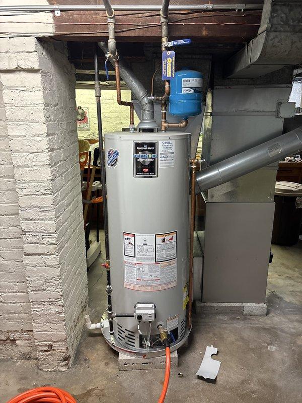 Completed annual water heater maintenance inspection on residential gas-fired water heater unit located in basement utility area. Performed comprehensive visual inspection of tank exterior, checking for signs of corrosion, rust, or leaking. Examined all plumbing connections including hot and cold water supply lines, temperature and pressure relief valve, and discharge piping for proper installation and function. Inspected expansion tank mounting and verified proper air pressure. Tested temperature and pressure relief valve operation and confirmed proper discharge tube routing to floor level. Verified all gas connections were secure with no detectable leaks. Checked burner assembly combustion and confirmed proper venting through exhaust flue system. Unit found to be operating within manufacturer specifications with all safety systems functioning correctly.