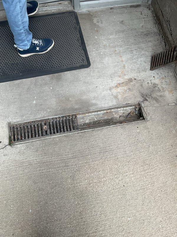 Completed routine maintenance inspection on sump pump system and outdoor storm water drainage components for twenty-year-old residential property. Inspected exterior drainage grates at building entrance and walkway areas, verified proper water flow channels, and assessed concrete surfaces for drainage efficiency. All equipment found operating within normal parameters with no immediate service requirements identified.