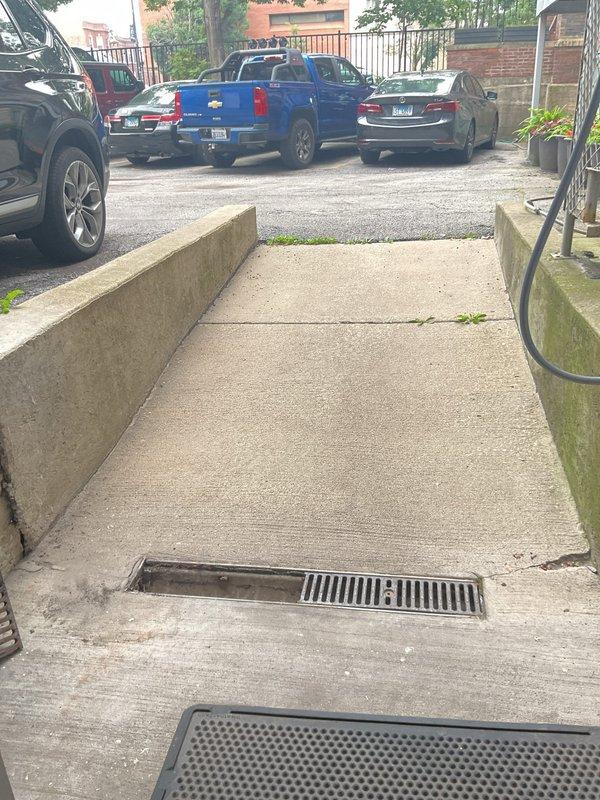 Completed routine maintenance inspection on sump pump system and outdoor storm water drainage components for twenty-year-old residential property. Inspected exterior drainage grates at building entrance and walkway areas, verified proper water flow channels, and assessed concrete surfaces for drainage efficiency. All equipment found operating within normal parameters with no immediate service requirements identified.