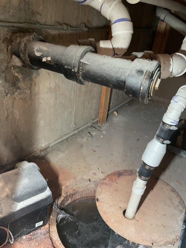 Responded to priority main drain backup causing water to back up through basement floor drain. Upon arrival, inspected basement plumbing system and identified blockage in main sewer line affecting drainage throughout the home. Assessed existing plumbing infrastructure including sump pump system, main drain lines, and PVC drainage piping. Performed drain cleaning procedure using professional augering equipment to clear obstruction in main line. Successfully restored proper drainage flow and verified system operation. Tested floor drain and confirmed water now draining properly without backup. Advised on preventative maintenance for aging plumbing system in 27-year-old home.