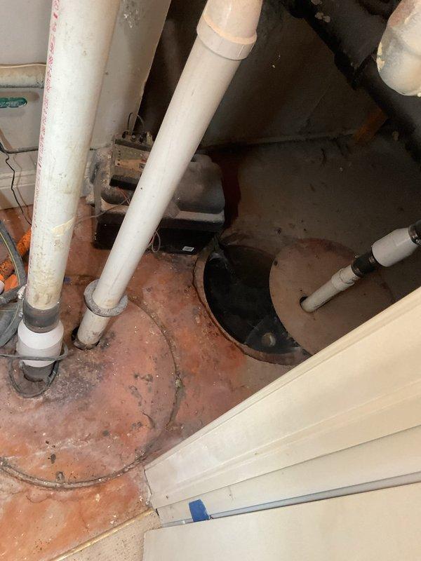 Responded to priority main drain backup causing water to back up through basement floor drain. Upon arrival, inspected basement plumbing system and identified blockage in main sewer line affecting drainage throughout the home. Assessed existing plumbing infrastructure including sump pump system, main drain lines, and PVC drainage piping. Performed drain cleaning procedure using professional augering equipment to clear obstruction in main line. Successfully restored proper drainage flow and verified system operation. Tested floor drain and confirmed water now draining properly without backup. Advised on preventative maintenance for aging plumbing system in 27-year-old home.