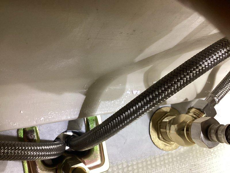 Senior technician dispatched to address faucet installation issues from previous service visit. Upon inspection, verified proper installation of braided stainless steel supply lines with secure mounting clips and brass compression fittings under sink. Completed installation of wall-mounted chrome faucet with dual lever handles, ensuring proper function and alignment with undermount basin in marble countertop.