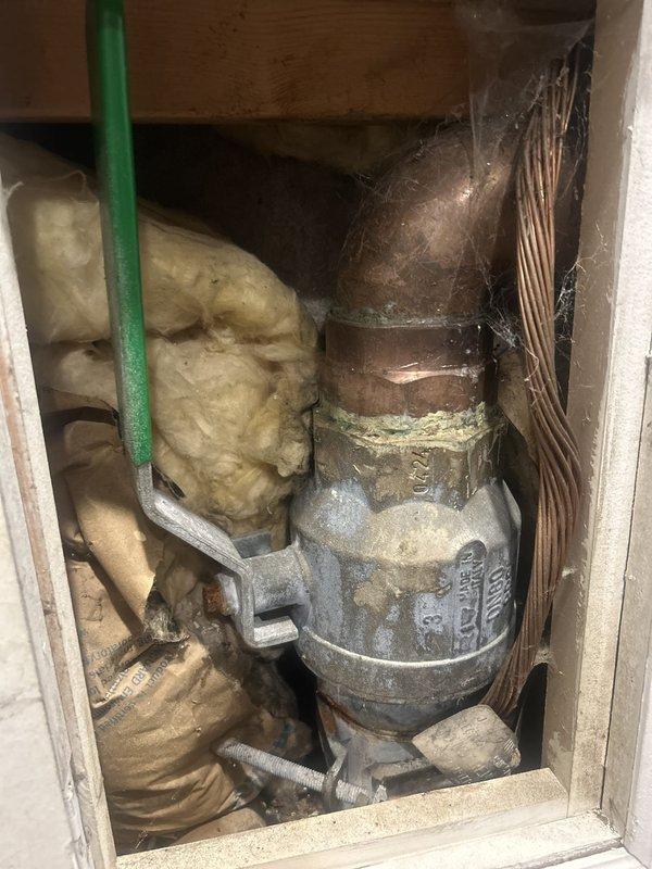Coordinated with city utility department for scheduled water shutoff at 11am to complete sold plumbing repair work. Accessed cramped utility space containing aged valve assembly, galvanized piping, and mechanical components requiring service. Completed repair work on plumbing system components located behind access panel in living area, ensuring proper function and restoration of water service following city shutoff coordination.