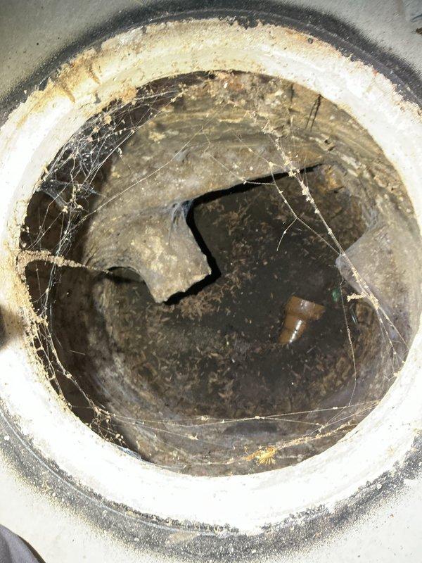Completed comprehensive drain and sewer estimate for recurring basement floor drain backup issue in 120-year-old residential property. Basement floor drain experiences water backflow during rain events, indicating potential main line obstruction, inadequate drainage capacity, or lack of backwater valve protection. Conducted thorough inspection of basement plumbing system, including floor drain assembly, overhead drainage piping, and visible sewer connections. Documented heavily soiled floor drain opening with significant grime accumulation, cobweb presence, and evidence of standing water staining, confirming chronic backup conditions. Assessed existing plumbing configuration including PVC and copper supply lines, drainage routing through floor joists, and connection points in utility area near laundry equipment. Evaluated age-related deterioration of drainage infrastructure and determined scope of work required for permanent remediation. Provided estimate options for backwater valve in