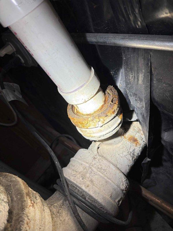 Completed comprehensive plumbing maintenance inspection on historic property. Performed tankless water heater flush and descaling service to remove mineral buildup and maintain optimal efficiency. Inspected sump pump operation and verified proper function and discharge. Evaluated outdoor basement drain for drainage concerns and cleared minor debris obstruction. Addressed leaking outdoor hose spigot connection, identifying worn packing washer causing water seepage around handle stem. Replaced packing washer and tightened compression nut to eliminate leak. Documented significant corrosion on water heater internal components and pipe fittings, noting rust accumulation on threaded connections and mineral deposits on tank interior surfaces. All systems tested and confirmed operational following maintenance procedures.