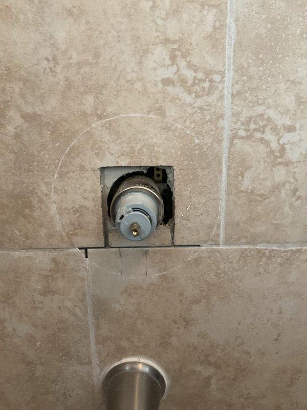 Responded to customer complaint of temperature control issues in two shower/tub combinations where handles would only produce warm or hot water with no cold water option. Inspected both shower valve assemblies and identified faulty thermostatic cartridges preventing proper mixing of hot and cold water supply lines. Removed existing valve trim and accessed valve bodies through tiled wall openings. Replaced defective cartridges in both shower valves, tested temperature range functionality, and verified full operation from cold to hot settings. Reinstalled trim plates and confirmed proper handle operation with customer present.