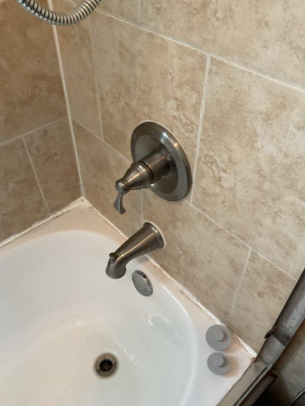 Responded to customer complaint of temperature control issues in two shower/tub combinations where handles would only produce warm or hot water with no cold water option. Inspected both shower valve assemblies and identified faulty thermostatic cartridges preventing proper mixing of hot and cold water supply lines. Removed existing valve trim and accessed valve bodies through tiled wall openings. Replaced defective cartridges in both shower valves, tested temperature range functionality, and verified full operation from cold to hot settings. Reinstalled trim plates and confirmed proper handle operation with customer present.