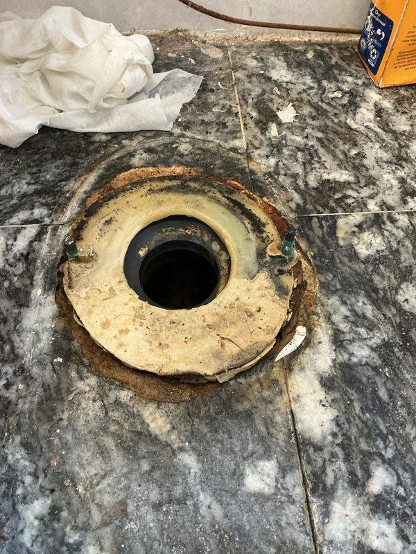Responded to water leak originating from second floor bathroom that caused drywall damage in first floor bathroom ceiling below. Upon inspection, identified corroded and deteriorating drain flange at bathroom sink as primary source of leak. Drain assembly showed significant rust staining, mineral deposits, and compromised seal where flange meets countertop surface. Removed failed drain components and cleaned mounting area of debris and corrosion. Installed new drain assembly with proper sealing to prevent future water intrusion. Verified proper drainage function and checked for leaks under pressure. Advised property owner that damaged drywall in first floor bathroom ceiling will require separate repair by qualified contractor once area has fully dried.
