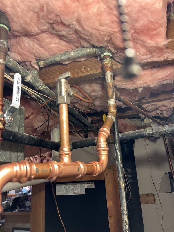 Responded to service call for leaking hot water heater in residential property. Upon inspection, identified active leak from aging tanked water heater system with deteriorated connections and compromised tank integrity. Assessed existing copper and steel piping configuration in basement installation area. Evaluated iCON System electronic control unit functionality and determined unit required replacement due to leak severity and age-related component failure. Completed water heater replacement with new tanked unit, reconnected existing plumbing lines, verified all connections for proper seal, tested system operation including temperature controls and safety features, and confirmed no active leaks present upon completion.