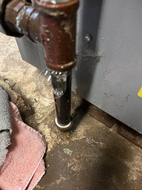 Responded to emergency gas service call after utility company identified multiple gas leaks and shut off gas supply to the property. Conducted comprehensive pressure testing of gas distribution system to identify leak locations throughout the building. Inspection revealed severely corroded copper connections at HVAC equipment interface and deteriorated gas piping components along basement foundation wall with aged brass valve fittings and yellow CSST flexible gas line showing signs of environmental exposure and potential compromise points in the system.