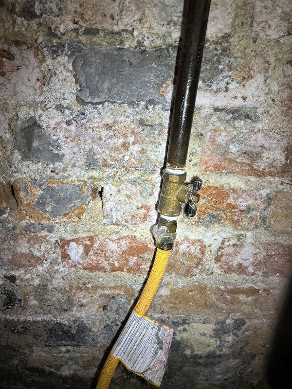 Responded to emergency gas service call after utility company identified multiple gas leaks and shut off gas supply to the property. Conducted comprehensive pressure testing of gas distribution system to identify leak locations throughout the building. Inspection revealed severely corroded copper connections at HVAC equipment interface and deteriorated gas piping components along basement foundation wall with aged brass valve fittings and yellow CSST flexible gas line showing signs of environmental exposure and potential compromise points in the system.