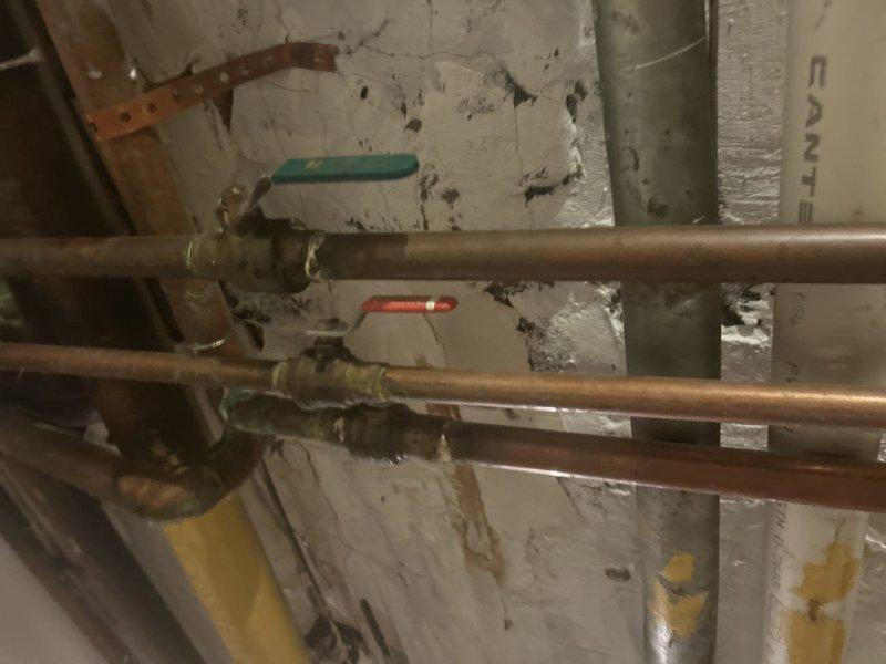Coordinated scheduled water shut down with building management to facilitate plumbing repairs on aging copper supply lines and ball valve assembly. Replaced deteriorated brass valves showing corrosion and oxidation, addressing potential leak points in the horizontal piping system located in the utility area. Work was completed during mid-morning hours to minimize disruption to building residents.